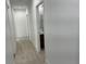 Hallway with tile floors and doors to bedrooms and bathroom at 1204 Vero Beach Way, Poinciana, FL 34759