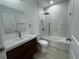 Modern bathroom with tub, floating vanity, and tile flooring at 1204 Vero Beach Way, Poinciana, FL 34759