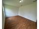 Simple bedroom with wood floors and multiple electrical outlets at 1204 Vero Beach Way, Poinciana, FL 34759