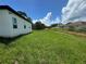 Single story home with grassy backyard and clear skies at 1204 Vero Beach Way, Poinciana, FL 34759
