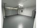 Spacious garage with freshly painted floor and overhead storage at 1204 Vero Beach Way, Poinciana, FL 34759