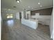 Modern kitchen with island, light wood cabinets, and white countertops at 1204 Vero Beach Way, Poinciana, FL 34759