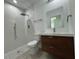 Modern bathroom with walk-in shower, floating vanity, and tile flooring at 1204 Vero Beach Way, Poinciana, FL 34759