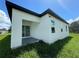 New construction home exterior showcasing a modern design and covered patio at 1204 Vero Beach Way, Poinciana, FL 34759