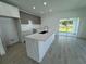Modern kitchen with island, stainless steel appliances, and tile flooring at 1204 Vero Beach Way, Poinciana, FL 34759