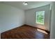 Spacious bedroom with wood flooring and a large window at 1204 Vero Beach Way, Poinciana, FL 34759