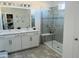 Bathroom with double vanity, a large walk in shower, and gray tile at 5336 Jubiloso Dr, Saint Cloud, FL 34771