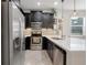 Modern kitchen with dark cabinetry, white countertops, and stainless steel appliances at 2917 Windmill Dr, Kissimmee, FL 34741