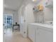 Convenient laundry room with washer, dryer and overhead shelving at 2917 Windmill Dr, Kissimmee, FL 34741