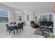 Bright dining room with glass table and chairs, open to living room at 2917 Windmill Dr, Kissimmee, FL 34741