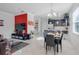 Open concept dining room and living area with dark furniture and a glass dining table at 2917 Windmill Dr, Kissimmee, FL 34741