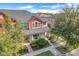 Two-story townhome, gray roof, red accents, landscaped yard, and walkway at 2917 Windmill Dr, Kissimmee, FL 34741