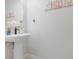 Clean powder room with pedestal sink and decorative wall art at 2917 Windmill Dr, Kissimmee, FL 34741