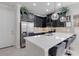 Modern kitchen with dark cabinetry, white countertops, and stainless steel appliances at 2917 Windmill Dr, Kissimmee, FL 34741