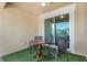Small balcony with table and chairs, and sliding glass doors at 2917 Windmill Dr, Kissimmee, FL 34741