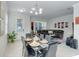 Open concept dining room with glass table and chairs, adjacent to living room at 2917 Windmill Dr, Kissimmee, FL 34741