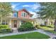 Two-story townhome with red accents and front porch at 2917 Windmill Dr, Kissimmee, FL 34741