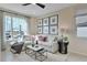 Bright living room with sectional sofa, large window, and stylish decor at 510 Summit River Dr, Apopka, FL 32712