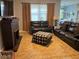 Spacious living room with leather sofas, a fireplace, and large windows at 3450 Marshfield Preserve Way, Kissimmee, FL 34746