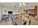 Bright dining area with dark wood table, chandelier, and view of kitchen at 274 Captiva Dr, Davenport, FL 33896