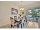 Bright dining room with table, chairs, and view of the pool at 274 Captiva Dr, Davenport, FL 33896