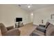 Cozy sitting area with two armchairs and a flat-screen TV at 274 Captiva Dr, Davenport, FL 33896
