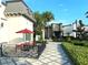 Outdoor patio seating area with red umbrella and bistro table at 274 Captiva Dr, Davenport, FL 33896