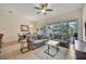 Comfortable living room with grey sofas, sliding glass doors, and a view of the backyard at 274 Captiva Dr, Davenport, FL 33896