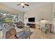 Relaxing living room with grey sofas, large TV, and access to backyard at 274 Captiva Dr, Davenport, FL 33896