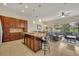 Spacious kitchen with granite island, stainless steel appliances, and dark wood cabinets at 274 Captiva Dr, Davenport, FL 33896
