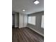 Spacious bedroom with wood-look flooring and large windows at 5819 Colchester Dr, Orlando, FL 32812