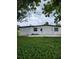 Rear view of a renovated house with a small patio and grassy yard at 5819 Colchester Dr, Orlando, FL 32812