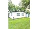 Landscaped front yard of a renovated house with a teal front door at 5819 Colchester Dr, Orlando, FL 32812