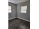 Bright bedroom featuring wood-look flooring and window at 5819 Colchester Dr, Orlando, FL 32812