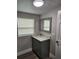 Bathroom with gray vanity and a large mirror at 5819 Colchester Dr, Orlando, FL 32812