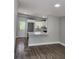 Open concept kitchen with island and gray flooring at 5819 Colchester Dr, Orlando, FL 32812