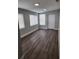 Bright living room with grey wood-look floors and neutral walls at 5819 Colchester Dr, Orlando, FL 32812
