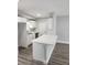 Modern kitchen with white cabinets and a large island at 5819 Colchester Dr, Orlando, FL 32812