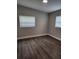 Bright bedroom with window blinds and grey wood-look flooring at 5819 Colchester Dr, Orlando, FL 32812