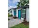 Newly renovated home with teal doors and white exterior at 5819 Colchester Dr, Orlando, FL 32812