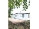 Side view of a renovated house with a concrete patio and grassy yard at 5819 Colchester Dr, Orlando, FL 32812