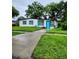 Newly renovated home with a teal door and white exterior at 5819 Colchester Dr, Orlando, FL 32812