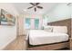 King-size bed and mounted TV in a bright bedroom with wood floors at 3037 Sea Plane Ln, Kissimmee, FL 34747