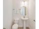 Clean and modern bathroom with pedestal sink and oval mirror at 3037 Sea Plane Ln, Kissimmee, FL 34747