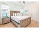 Main bedroom with a king-size bed and wood frame, featuring coastal decor at 3037 Sea Plane Ln, Kissimmee, FL 34747