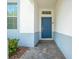 Inviting entryway with a blue door and a stone walkway at 4722 Sleepy Hollow Dr, Kissimmee, FL 34746