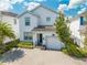 Two-story house with gray and white exterior, paver driveway, and landscaping at 4722 Sleepy Hollow Dr, Kissimmee, FL 34746