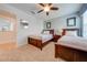 Bedroom with two twin beds, ceiling fan, and carpet flooring at 4722 Sleepy Hollow Dr, Kissimmee, FL 34746