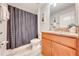 Clean bathroom with shower/tub combo, granite countertop, and dark-colored shower curtain at 4722 Sleepy Hollow Dr, Kissimmee, FL 34746
