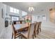 Spacious dining room with large table and chairs, hardwood floors, and a modern chandelier at 4722 Sleepy Hollow Dr, Kissimmee, FL 34746